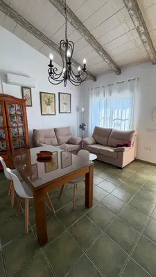 a bedroom with two beds and a pink curtain at Villa Ojos Del Océano in Cádiz
