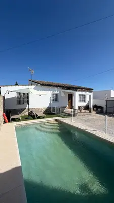 a swimming pool in front of a house at Villa Ojos Del Océano in Cádiz
