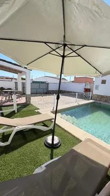 a kitchen and living room with a table and a couch at Villa Ojos Del Océano in Cádiz