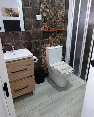 a bathroom with a toilet and a sink at Casa Sahar in Arcos de la Frontera