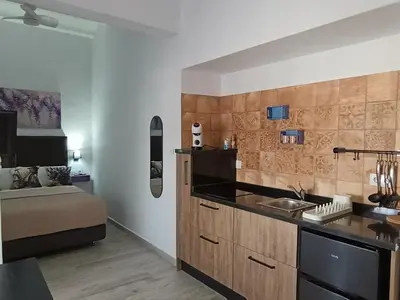 a kitchen with a sink and a bed in a room at Casa Sahar in Arcos de la Frontera