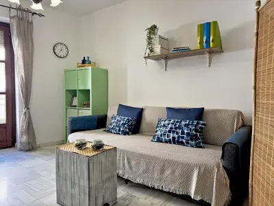 a living room with a couch and a table at Apartamento Las Palmeras - Ole Solutions in Jerez de la Frontera