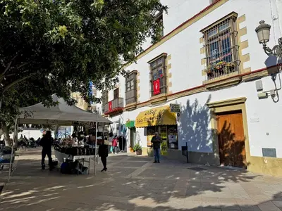 a group of people walking down a city street at Apartamento Las Palmeras - Ole Solutions in Jerez de la Frontera