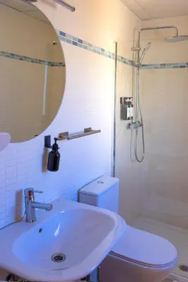 a large bed in a bedroom with a large window at Balcon mirador de las Salinas in Sanlúcar de Barrameda