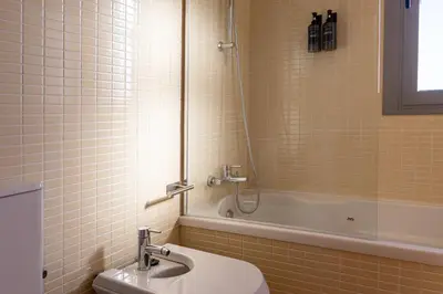 a bathroom with a sink and a mirror and a toilet at Balcon mirador de las Salinas in Sanlúcar de Barrameda