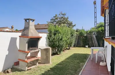 an outdoor pizza oven in the yard of a house at Casa Ana in Conil de la Frontera