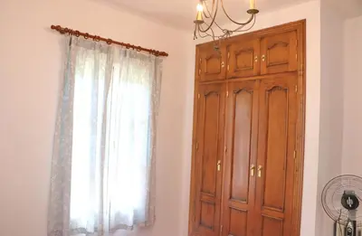 a room with a wooden cabinet and a window at Casa Ana in Conil de la Frontera