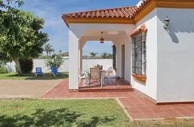 a small white house with a patio at Casa Ana in Conil de la Frontera
