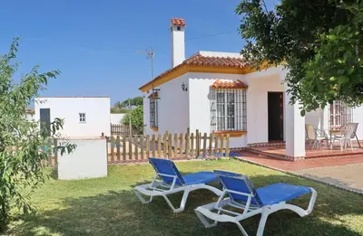 two blue chairs in front of a house at Casa Ana in Conil de la Frontera