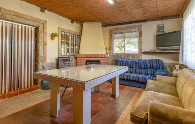 a living room with a table and a couch at Amazing Home In La Barca De La Florida in La Barca de la Florida