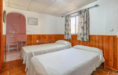 a bedroom with two beds and a window at Amazing Home In La Barca De La Florida in La Barca de la Florida
