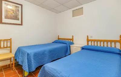 two beds in a room with blue sheets at Amazing Home In La Barca De La Florida in La Barca de la Florida
