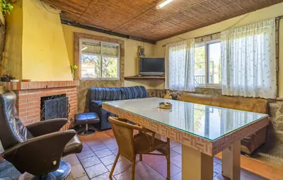 a living room with a table and a fireplace at Amazing Home In La Barca De La Florida in La Barca de la Florida