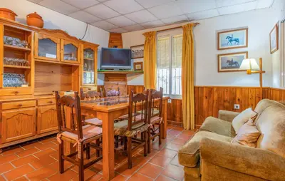 a living room with a wooden table and a couch at Amazing Home In La Barca De La Florida in La Barca de la Florida