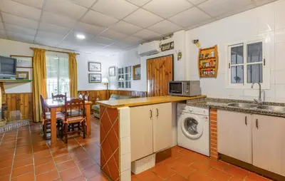 a kitchen with a sink and a washing machine at Amazing Home In La Barca De La Florida in La Barca de la Florida