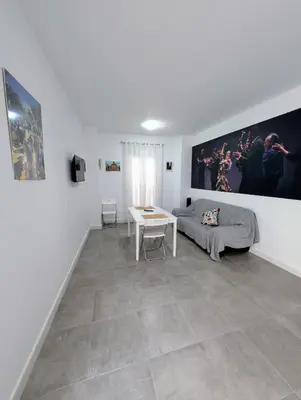 a living room with a couch and a table at A Jerez Apartamentos in Jerez de la Frontera