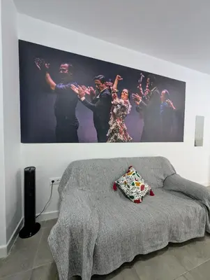 a painting of a group of people on a wall at A Jerez Apartamentos in Jerez de la Frontera