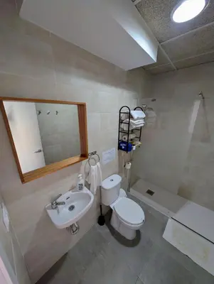 a bathroom with a sink and a toilet and a tub at A Jerez Apartamentos in Jerez de la Frontera