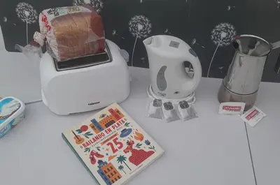 a book sitting on a counter next to a blender at A Jerez Apartamentos in Jerez de la Frontera