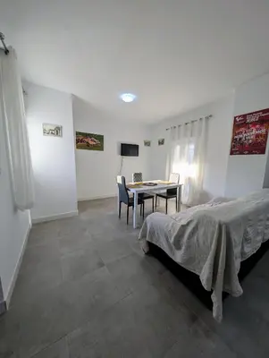 a bedroom with a bed and a table and chairs at A Jerez Apartamentos in Jerez de la Frontera