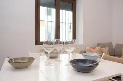 a table with three bowls and wine glasses on it at SibsSanlucar Carril San Diego 2 Coqueto Centrico Terraza in Sanlúcar de Barrameda