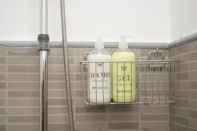 two bottles on a shelf in a bathroom at SibsSanlucar Carril San Diego 2 Coqueto Centrico Terraza in Sanlúcar de Barrameda