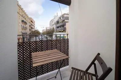 a balcony with a bench and a view of a city at SibsSanlucar Carril San Diego 2 Coqueto Centrico Terraza in Sanlúcar de Barrameda