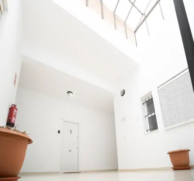a white room with a skylight and a window at SibsSanlucar Carril San Diego 2 Coqueto Centrico Terraza in Sanlúcar de Barrameda