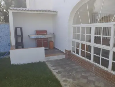 anterior view of a patio with a grill at Doña Violeta con jardin Grupo AC Gestion in Novo Sancti Petri