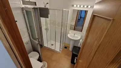 a bathroom with a toilet and a sink and a shower at Doña Violeta con jardin Grupo AC Gestion in Novo Sancti Petri
