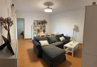 a living room with a couch and a table at Doña Violeta con jardin Grupo AC Gestion in Novo Sancti Petri