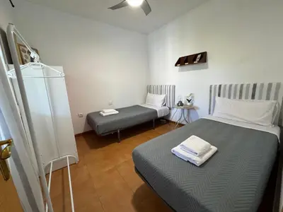 a small room with two beds and a couch at Doña Violeta con jardin Grupo AC Gestion in Novo Sancti Petri