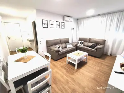 a bedroom with a bed with a black and white comforter at CITYHOUSE! NUEVO REFORMADO CONFORT WIFI TV65 AC FULL Visco in San Fernando