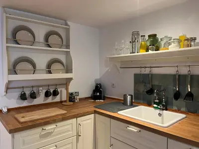 a kitchen with a sink and shelves with dishes at Loft Abril Grupo AC gestion in Cádiz