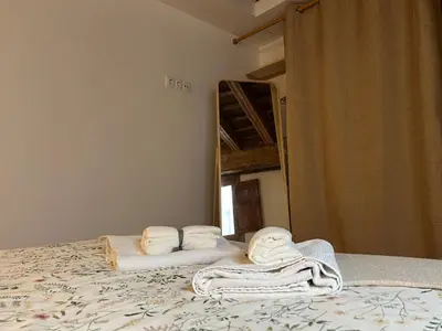 a bedroom with towels on a bed in front of a mirror at Loft Abril Grupo AC gestion in Cádiz