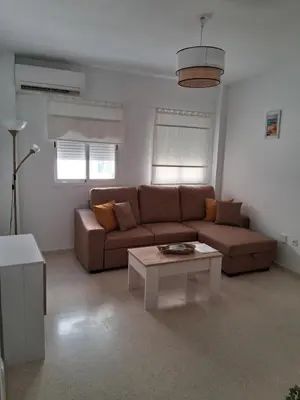 a living room with a couch and a coffee table at Apartamento Brisa Salada Center in Sanlúcar de Barrameda