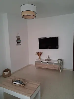 a living room with a flat screen tv on a wall at Apartamento Brisa Salada Center in Sanlúcar de Barrameda