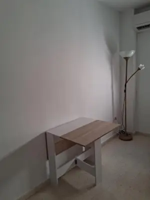 a wooden table in a room with a lamp at Apartamento Brisa Salada Center in Sanlúcar de Barrameda