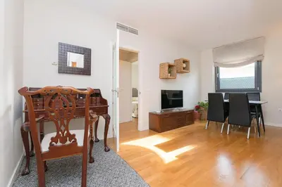 a living room with a table and a dining room at La Ronda - Cádiz in Jerez de la Frontera