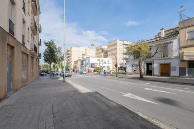 an empty street in a city with buildings at La Ronda - Cádiz in Jerez de la Frontera
