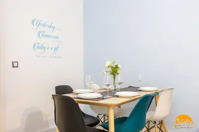 a dining room with a wooden table and chairs at Casa Lua by Cadiz Time in Cádiz