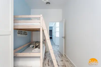 a room with two bunk beds and a hallway at Casa Lua by Cadiz Time in Cádiz