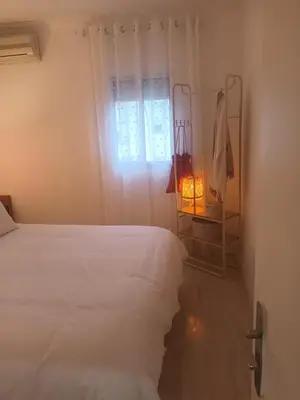 a bedroom with a white bed and a window at La Garatera in Jerez de la Frontera
