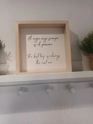 a framed picture on a shelf with writing on it at La Garatera in Jerez de la Frontera