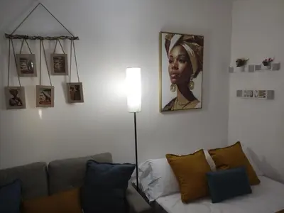a living room with a couch and a portrait of a woman at Apartamento Asis in Jerez de la Frontera