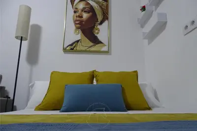 a small bedroom with a bed and a table at Apartamento Asis in Jerez de la Frontera