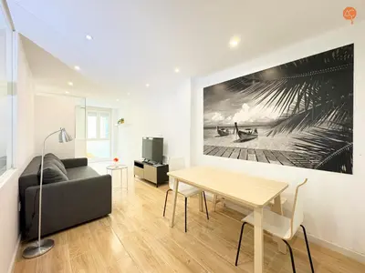 a living room with a table and a couch at La Suite de la Laguna Grupo AC Gestion in Cádiz