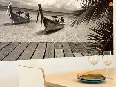 a table with two boats on the beach with wine glasses at La Suite de la Laguna Grupo AC Gestion in Cádiz