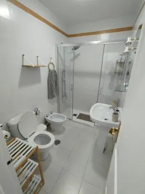 a bathroom with a toilet and a sink and a shower at Villa Playa in Novo Sancti Petri