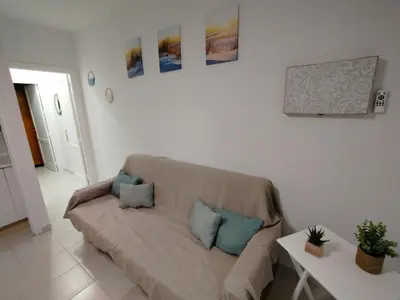 a living room with a couch and a table at Villa Playa in Novo Sancti Petri